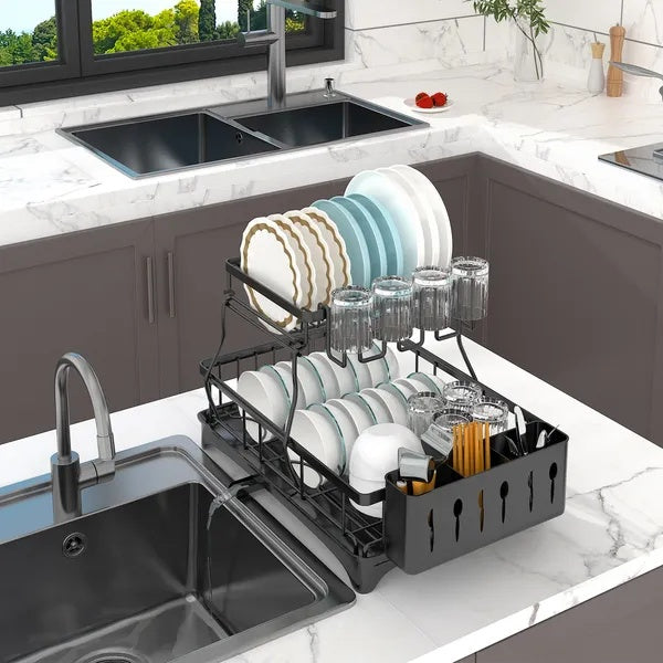Black dish rack with dishes on a kitchen counter next to a sink