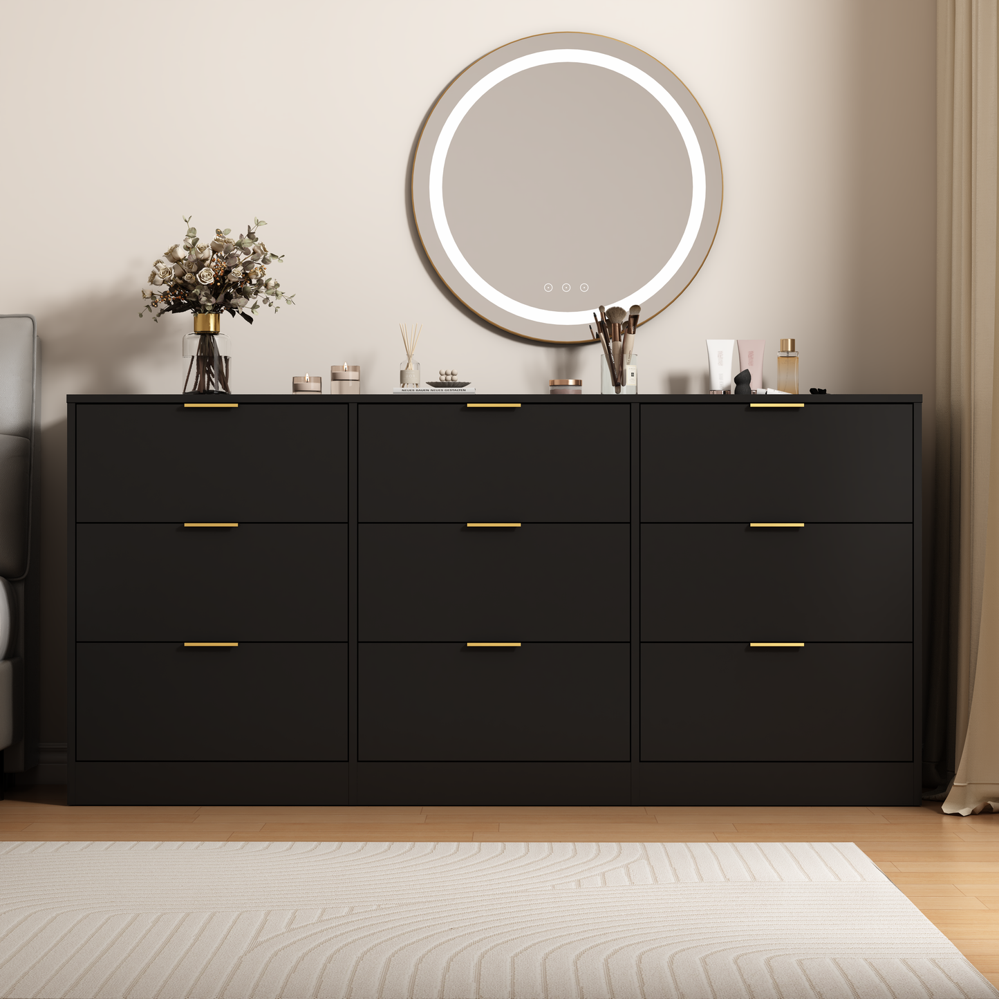 Black dresser with gold handles in a bedroom setting