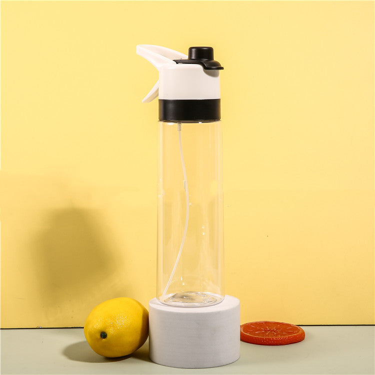 Clear glass bottle with white and black cap on a yellow background