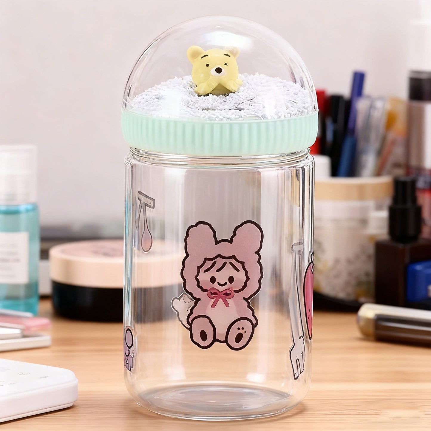 Clear jar with a cartoon character on a desk