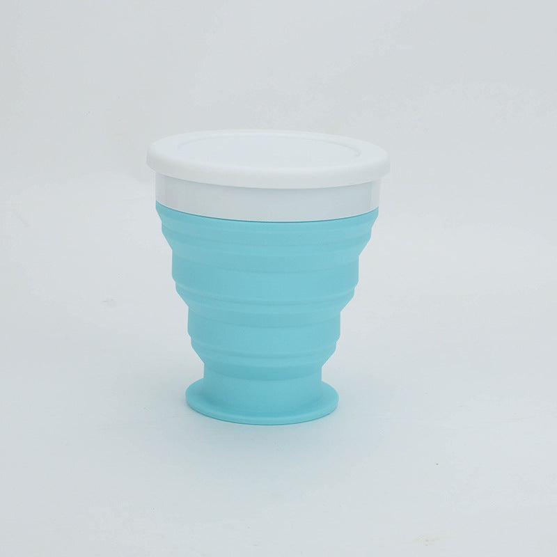 Collapsible blue cup with white top on a light gray background