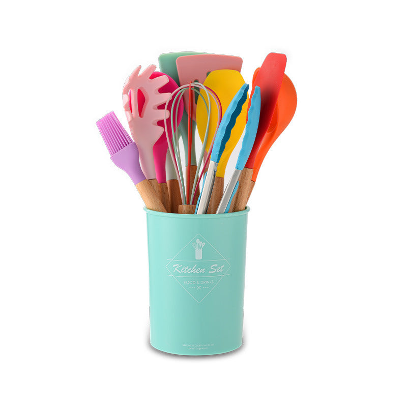 Colorful kitchen utensils set in a turquoise holder on a white background