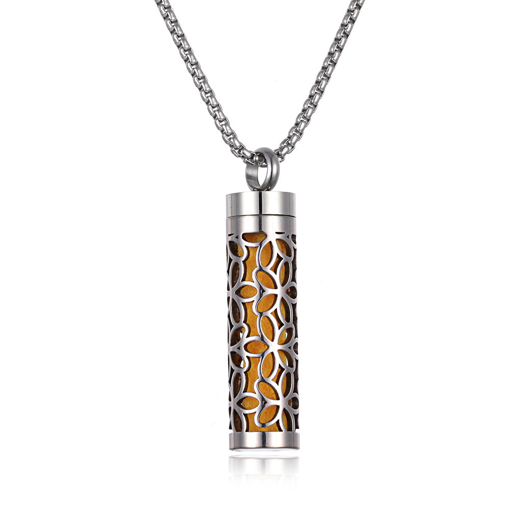 Cylindrical silver pendant with floral design on a white background