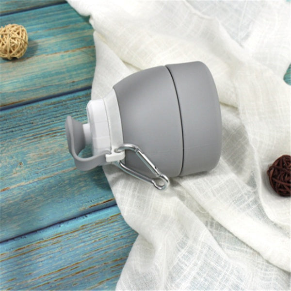 Gray container with a clip on a white fabric background