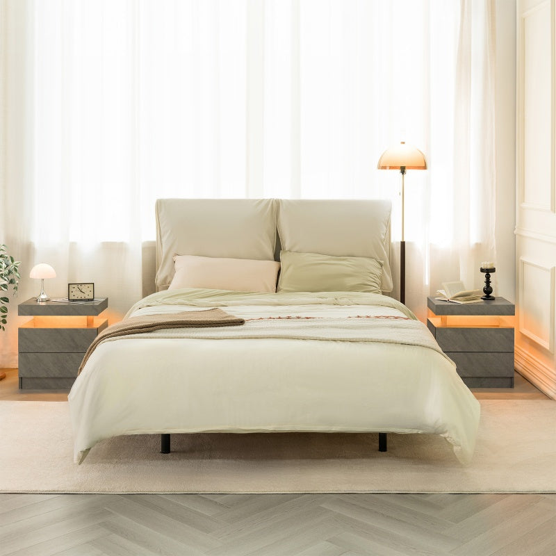 Neatly made bed with light bedding in a bright bedroom setting.