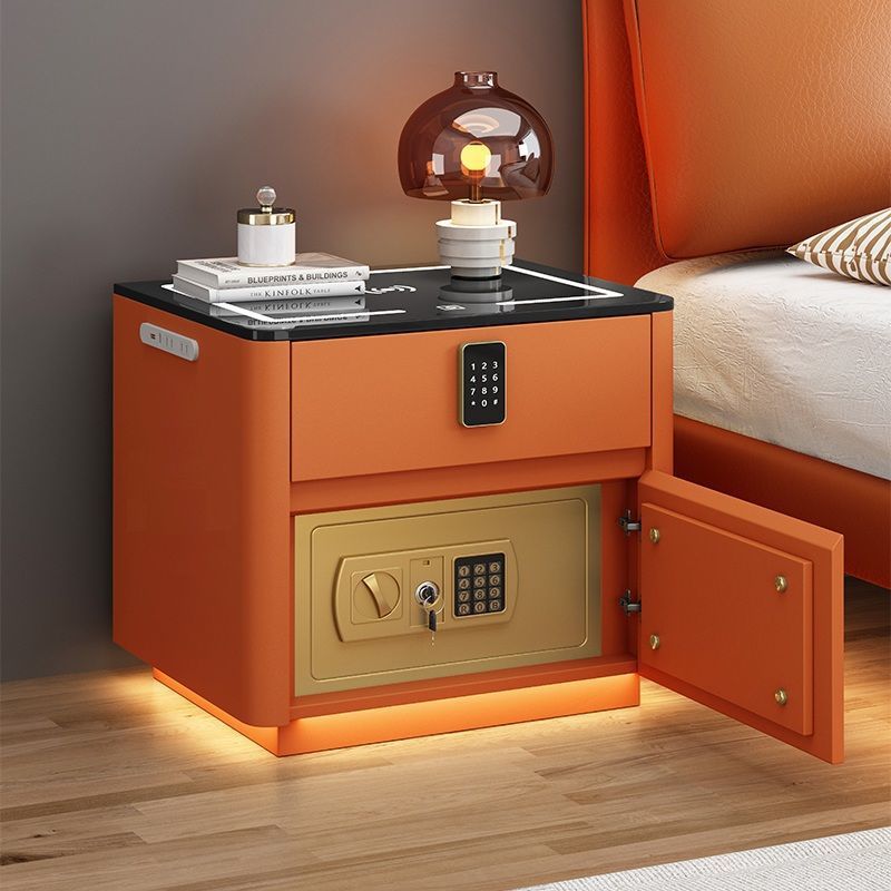 Orange nightstand with open safe compartment in a bedroom setting