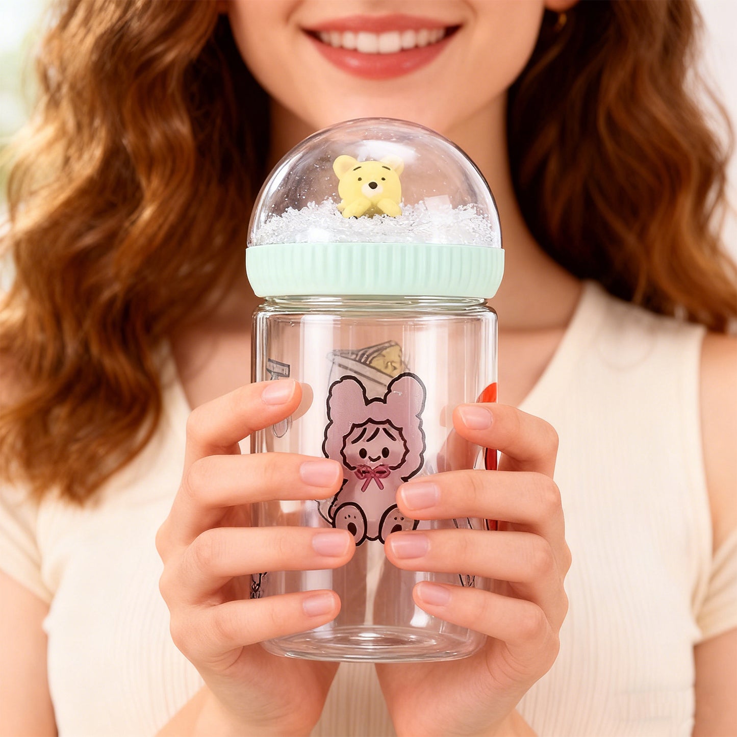 Person holding a clear container with a cartoon character on a light background