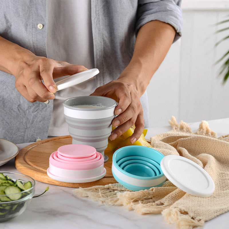Person using collapsible silicone bowls on a kitchen counter
