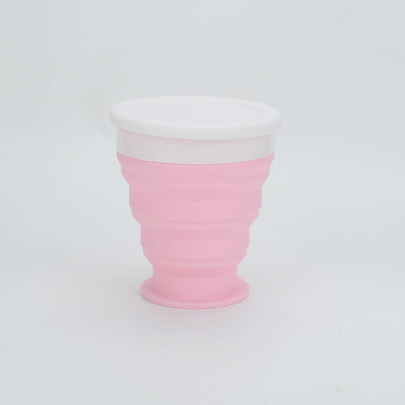 Pink silicone cup with white top on a light gray background
