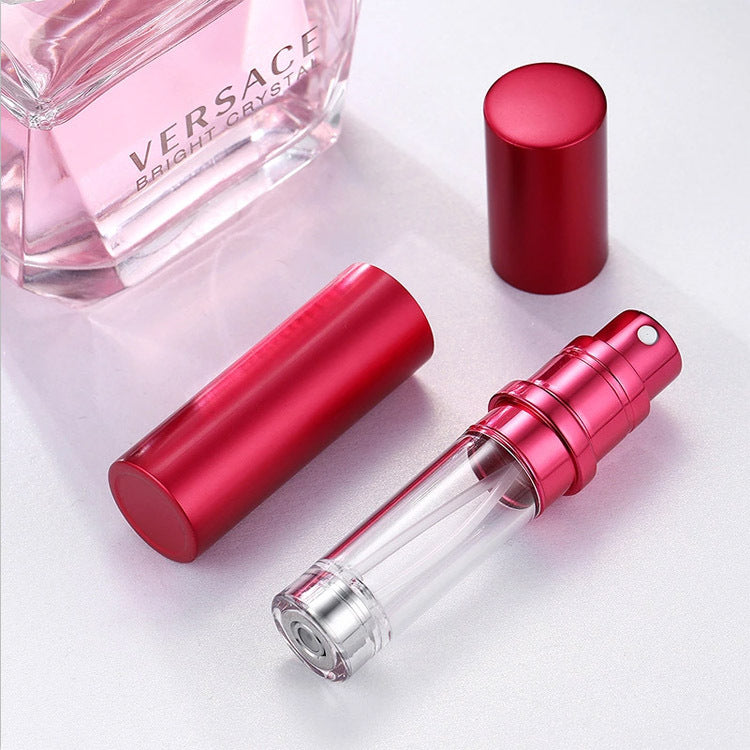 Red perfume bottle with clear cap on a light pink background