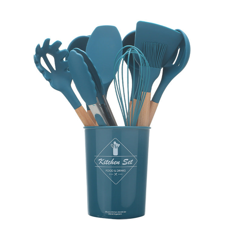 Set of blue kitchen utensils in a container on a white background