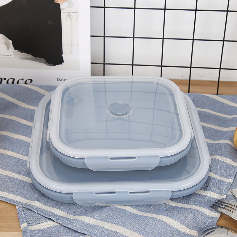 Set of collapsible silicone food containers on a striped cloth with a tiled wall background