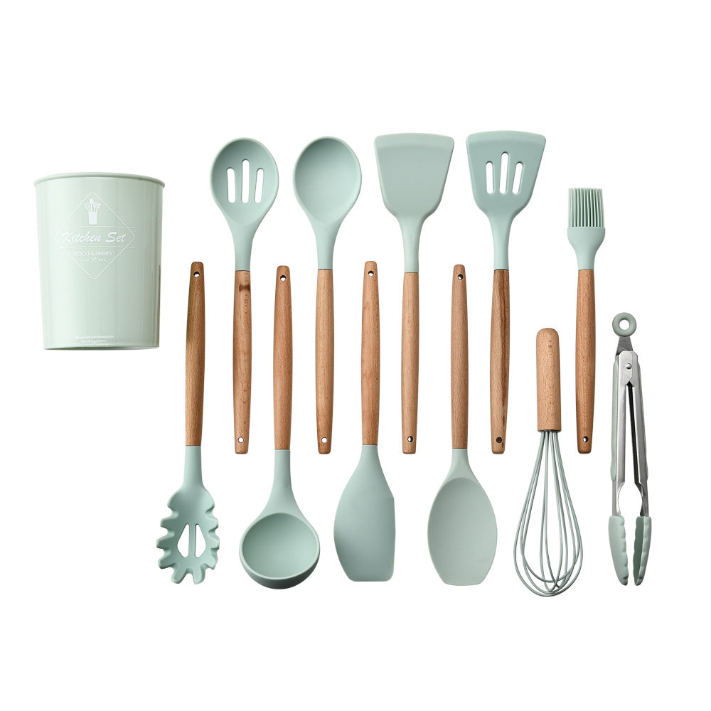 Set of kitchen utensils with green handles and wooden handles on a white background