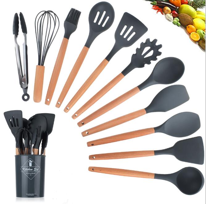 Set of kitchen utensils with wooden handles and black silicone ends, displayed with a container.