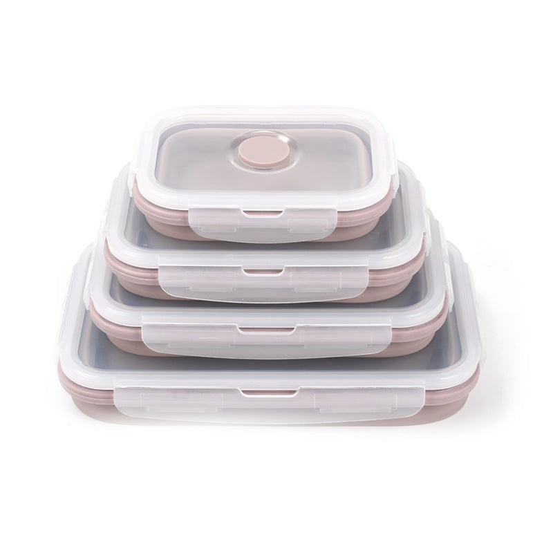 Set of three silicone food containers with lids on a white background