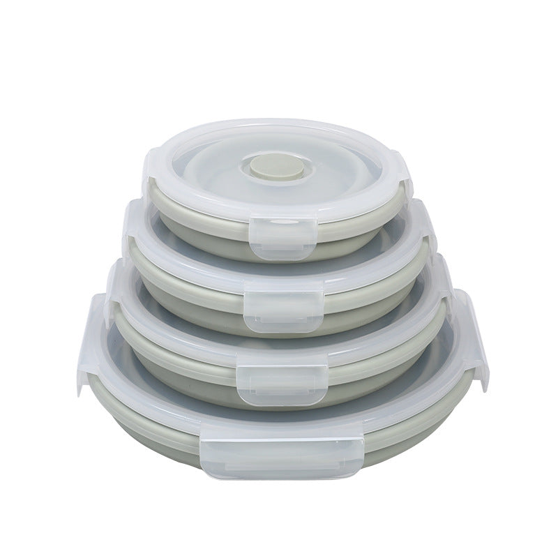 Set of three stackable silicone food containers with lids on a white background