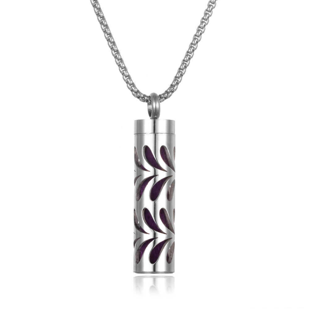 Silver cylindrical pendant with floral design on a white background