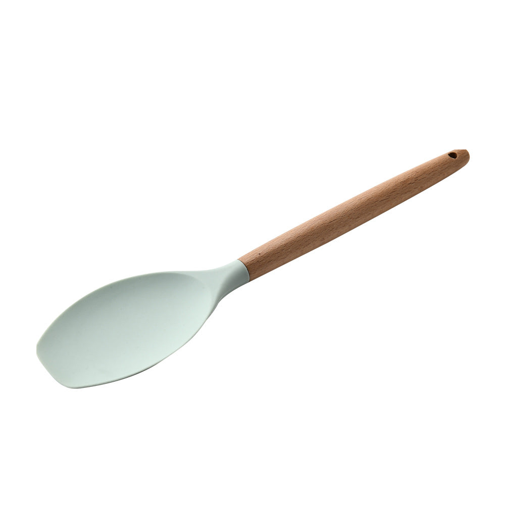 Spatula with a wooden handle and light blue head on a white background
