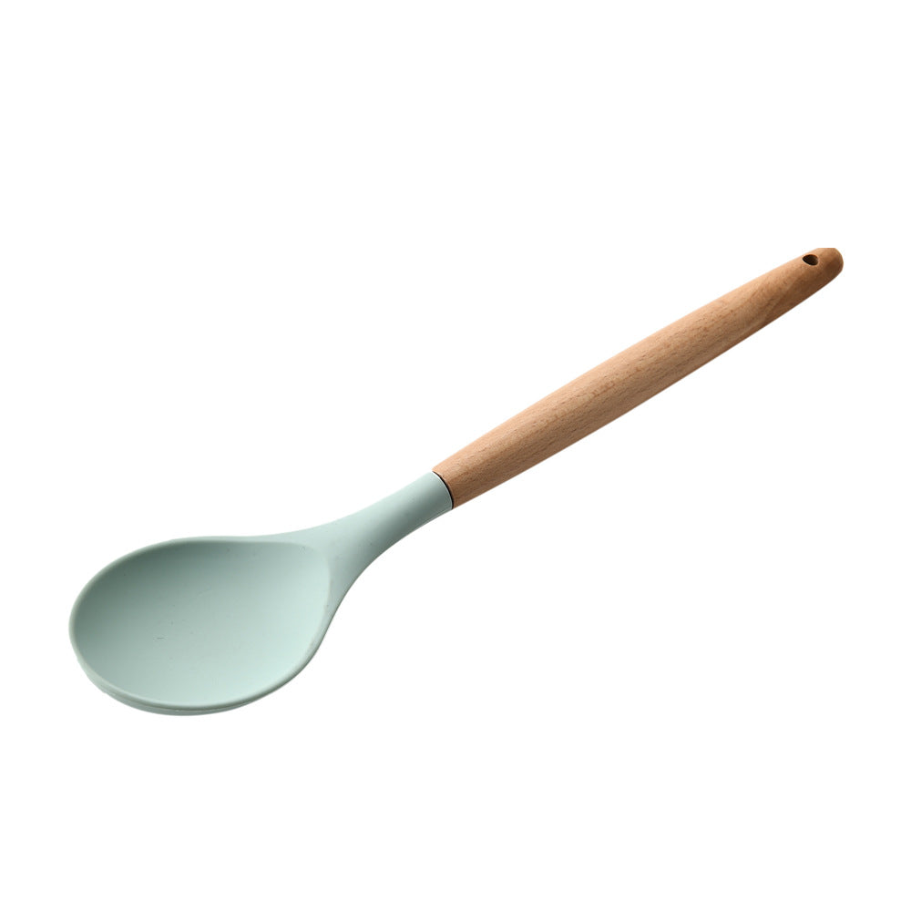 Spatula with a wooden handle and light blue head on a white background