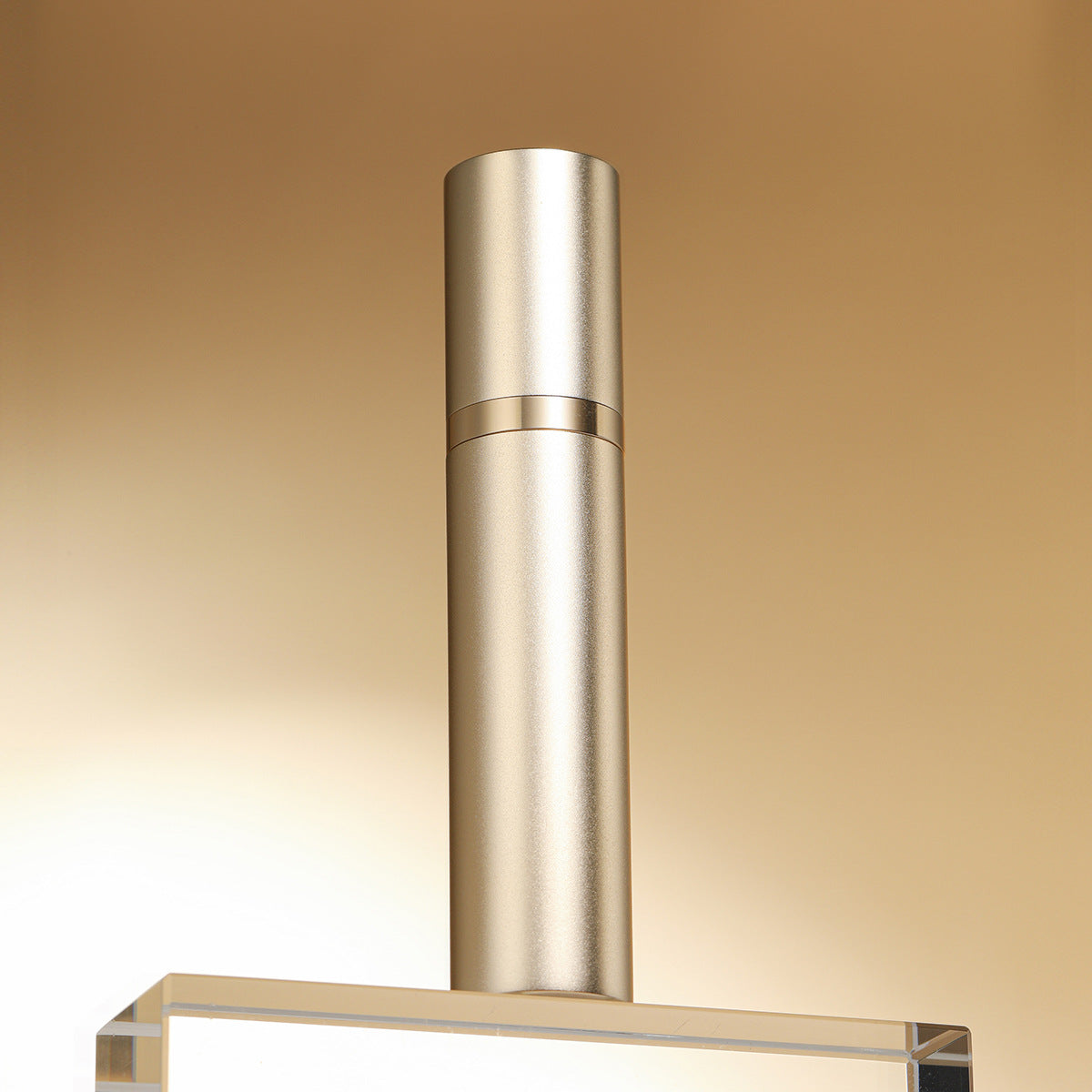 Stainless steel range hood on a gold gradient background