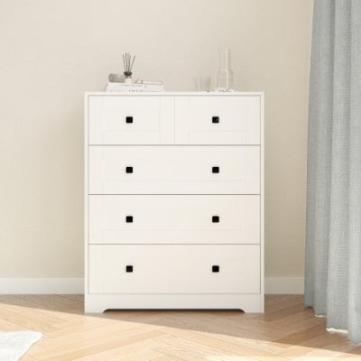 White dresser with five drawers in a room with beige walls and wooden flooring.