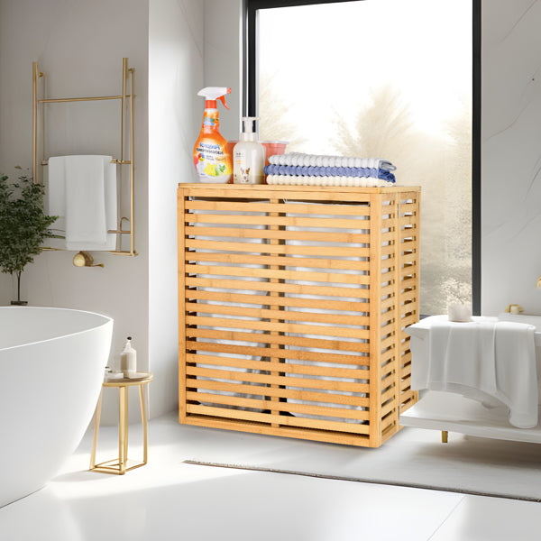 Wooden laundry basket in a bathroom with cleaning supplies on top